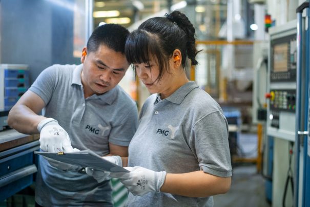 Nanjing Tech Week 2021 July 15, 2021, Shanghai China - (L-R): Zhou Ping and Liu Meiling at work in the SA area at the PMG factory.